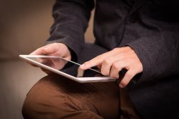 Foto eines Menschen mit einem Tablet in der Hand